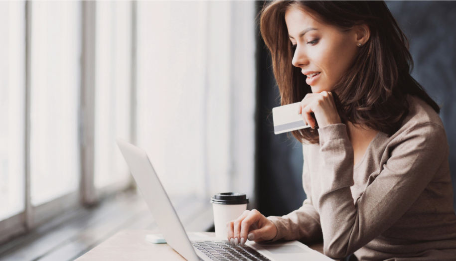 Woman shopping online with credit card on a laptop