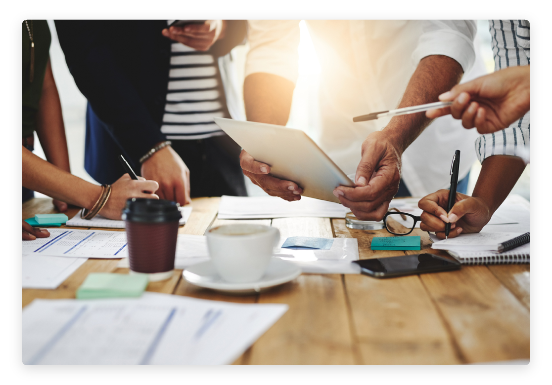 People working on a table with notepads